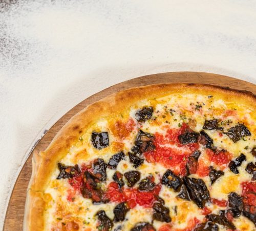 Pizza Aubergine Cheese Rustic Tomate Sauce Homemade Artesanale Close Up Detail on a Round Wooden Plate with Flour Background Table
